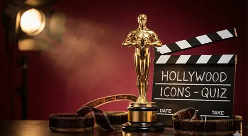 A vintage film reel and a director's clapboard resting on a wooden table with dramatic lighting